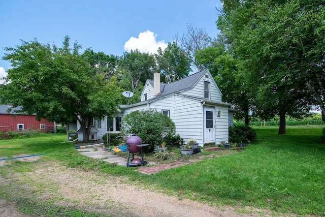 18726 Juneberry Rd, Mankato, MN 56001 - rear view of house featuring a chimney and a lawn
