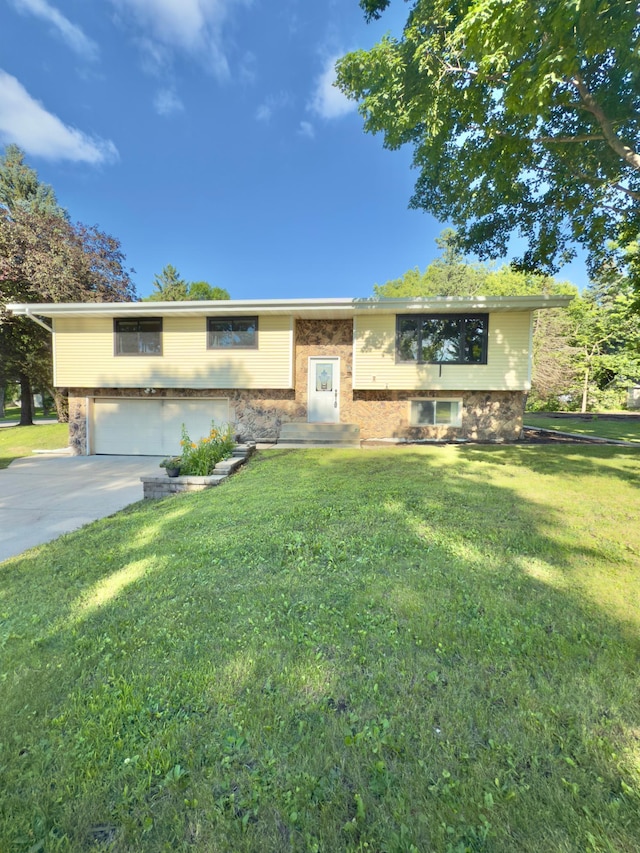 2001 25th St SW, Willmar, MN 56201 - bi-level home with concrete driveway, a garage, and a front lawn