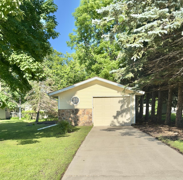 2001 25th St SW, Willmar, MN 56201 - view of front of home with stone siding, a garage, concrete driveway, and an outdoor structure