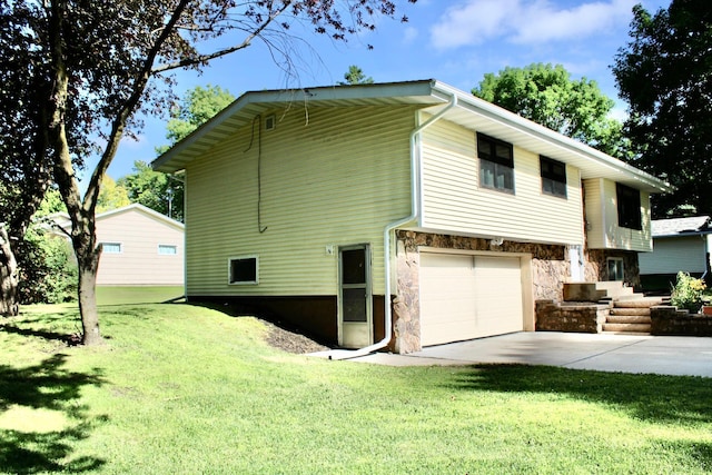 2001 25th St SW, Willmar, MN 56201 - view of side of home with stone siding, an attached garage, a yard, and concrete driveway