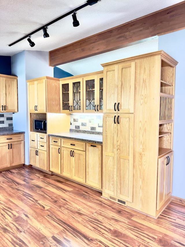 2001 25th St SW, Willmar, MN 56201 - kitchen with light brown cabinets, track lighting, backsplash, and light wood-style flooring