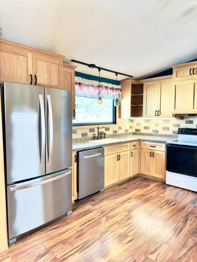2001 25th St SW, Willmar, MN 56201 - kitchen featuring appliances with stainless steel finishes, light brown cabinets, light wood-style floors, a textured ceiling, and open shelves