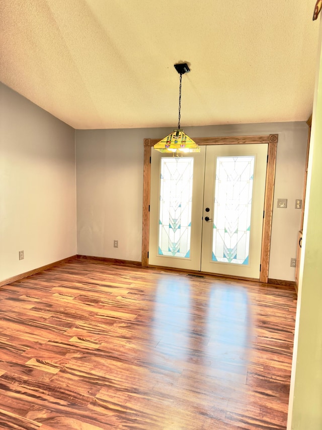 2001 25th St SW, Willmar, MN 56201 - foyer featuring wood finished floors, a textured ceiling, and french doors