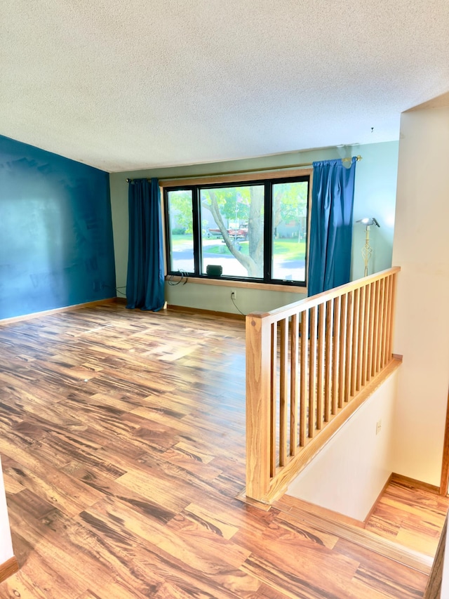 2001 25th St SW, Willmar, MN 56201 - spare room featuring a textured ceiling and wood finished floors