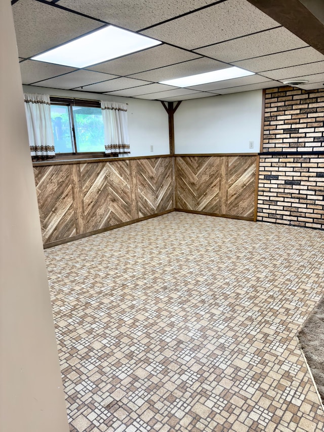 2001 25th St SW, Willmar, MN 56201 - below grade area with wainscoting, a paneled ceiling, and wood walls