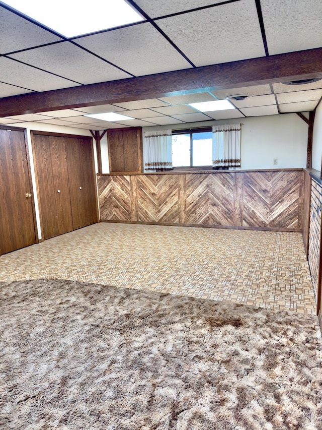 2001 25th St SW, Willmar, MN 56201 - below grade area featuring wooden walls, a drop ceiling, and wainscoting