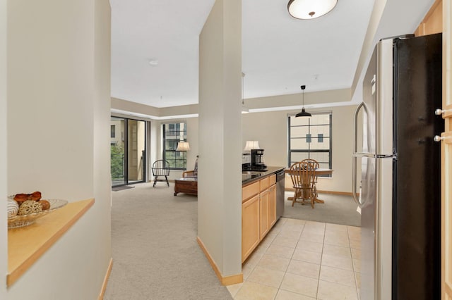 820 Emerald St SE Unit 314, Saint Paul, MN 55114 - kitchen with light colored carpet, appliances with stainless steel finishes, light brown cabinetry, dark countertops, and pendant lighting