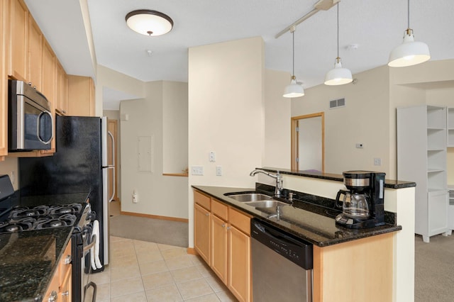 820 Emerald St SE Unit 314, Saint Paul, MN 55114 - kitchen featuring appliances with stainless steel finishes, light carpet, dark stone countertops, a peninsula, and light brown cabinetry