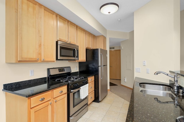820 Emerald St SE Unit 314, Saint Paul, MN 55114 - kitchen with stainless steel appliances, dark stone counters, light brown cabinets, and light tile patterned flooring