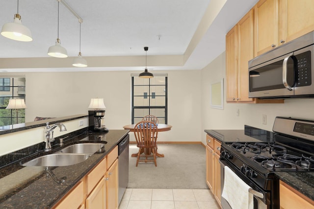 820 Emerald St SE Unit 314, Saint Paul, MN 55114 - kitchen with stainless steel appliances, light colored carpet, light tile patterned flooring, hanging light fixtures, and dark stone countertops