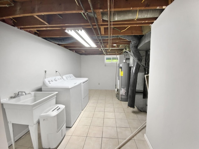 206 Winona St W, West Saint Paul, MN 55118 - washroom featuring water heater, washing machine and dryer, and light tile patterned floors