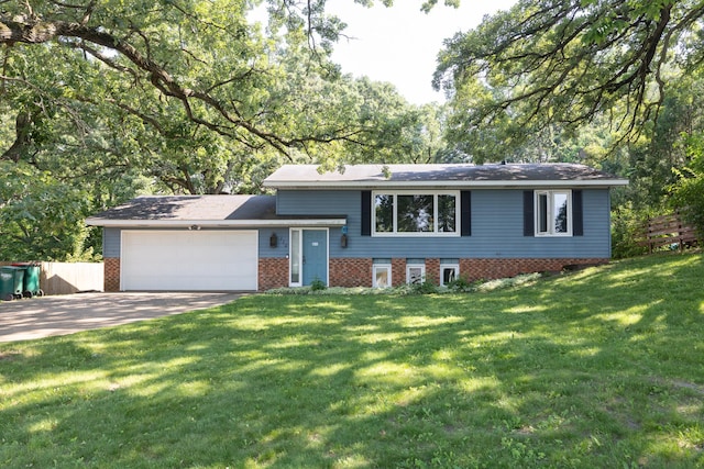 110 Hamilton Dr, River Falls, WI 54022 - split level home featuring concrete driveway, a garage, and brick siding