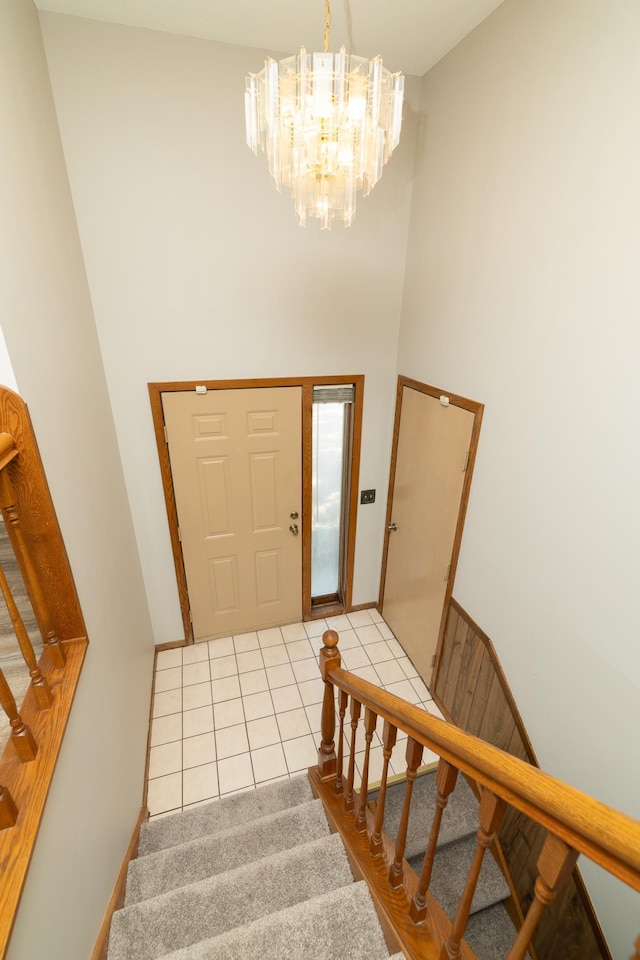 110 Hamilton Dr, River Falls, WI 54022 - foyer entrance with stairs, a towering ceiling, a chandelier, and light tile patterned floors