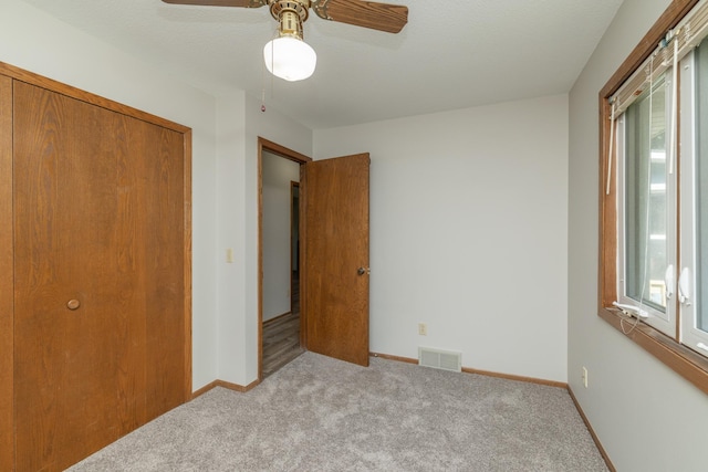 110 Hamilton Dr, River Falls, WI 54022 - unfurnished bedroom with multiple windows, carpet flooring, and ceiling fan