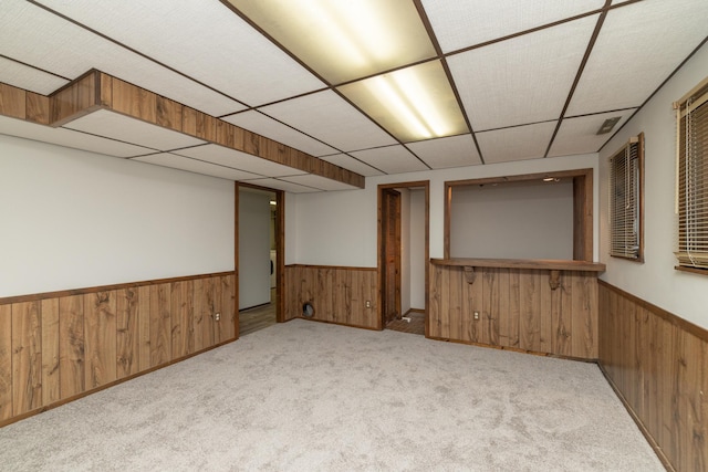110 Hamilton Dr, River Falls, WI 54022 - finished basement with a wainscoted wall, wood walls, a drop ceiling, light colored carpet, and washer / clothes dryer
