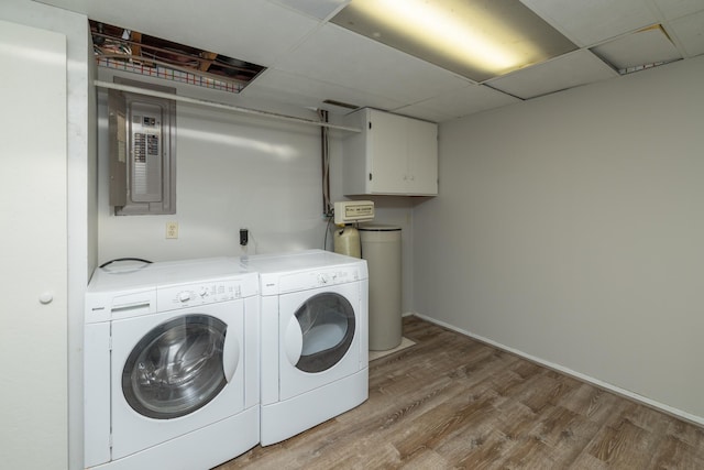 110 Hamilton Dr, River Falls, WI 54022 - washroom featuring washer and dryer, electric panel, wood finished floors, and cabinet space