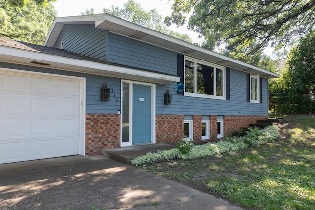 110 Hamilton Dr, River Falls, WI 54022 - view of front facade with brick siding and a garage