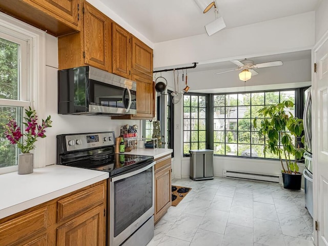 5529 1st Ave S, Minneapolis, MN 55419 - kitchen with stainless steel appliances, baseboard heating, light countertops, brown cabinets, and light marble finish floors