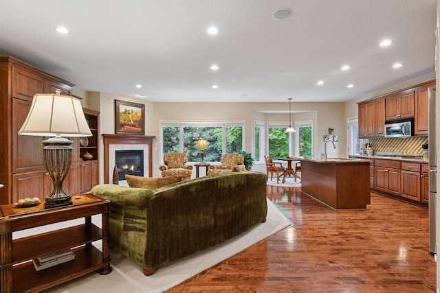 11444 Clarion Way, Minnetonka, MN 55343 - living area featuring recessed lighting, dark wood-type flooring, and a tiled fireplace