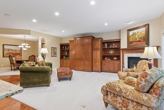 11444 Clarion Way, Minnetonka, MN 55343 - living area featuring a chandelier, a fireplace, recessed lighting, light wood-style flooring, and ornate columns