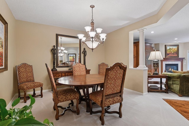 11444 Clarion Way, Minnetonka, MN 55343 - dining room featuring light carpet, decorative columns, a tile fireplace, a chandelier, and recessed lighting