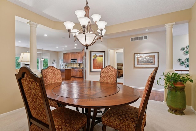 11444 Clarion Way, Minnetonka, MN 55343 - dining room with ornate columns, light carpet, a chandelier, and recessed lighting