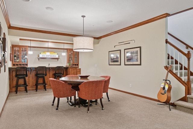 11444 Clarion Way, Minnetonka, MN 55343 - dining room featuring bar with sink, light carpet, stairs, and crown molding