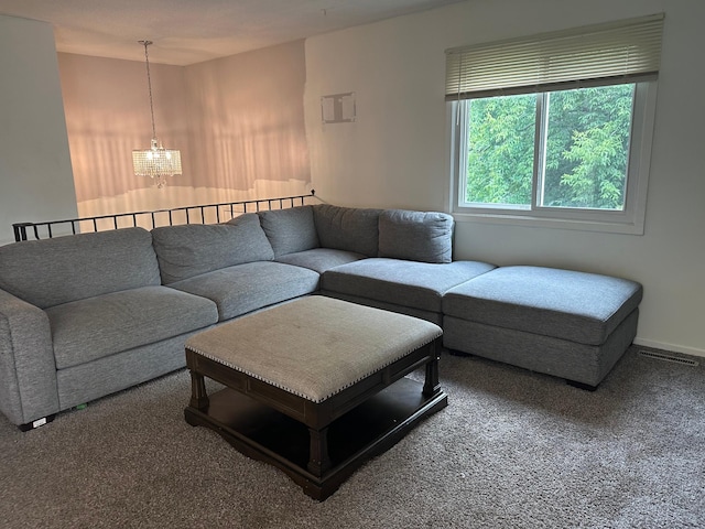2728 111th Ave NW, Coon Rapids, MN 55433 - carpeted living room featuring a chandelier and baseboards