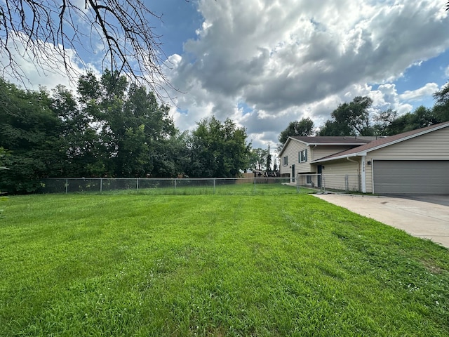 2728 111th Ave NW, Coon Rapids, MN 55433 - view of yard with a garage and concrete driveway