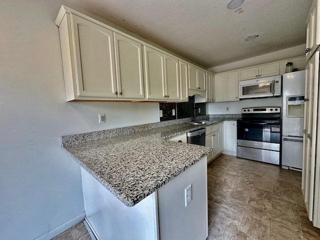 2728 111th Ave NW, Coon Rapids, MN 55433 - kitchen with stainless steel appliances, a peninsula, light stone counters, white cabinets, and a textured ceiling