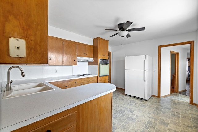 520 Park Island Rd Unit 2, Center City, MN 55012 - kitchen featuring white appliances, brown cabinetry, light countertops, under cabinet range hood, and ceiling fan