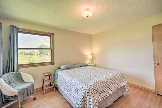 520 Park Island Rd Unit 2, Center City, MN 55012 - bedroom with light wood-style flooring and a textured ceiling