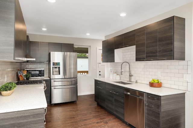 4640 Portland Ave, Minneapolis, MN 55407 - kitchen featuring stainless steel appliances, dark brown cabinetry, dark wood-style flooring, tasteful backsplash, and modern cabinets