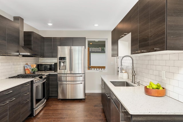 4640 Portland Ave, Minneapolis, MN 55407 - kitchen featuring appliances with stainless steel finishes, wall chimney exhaust hood, decorative backsplash, modern cabinets, and dark wood-style floors