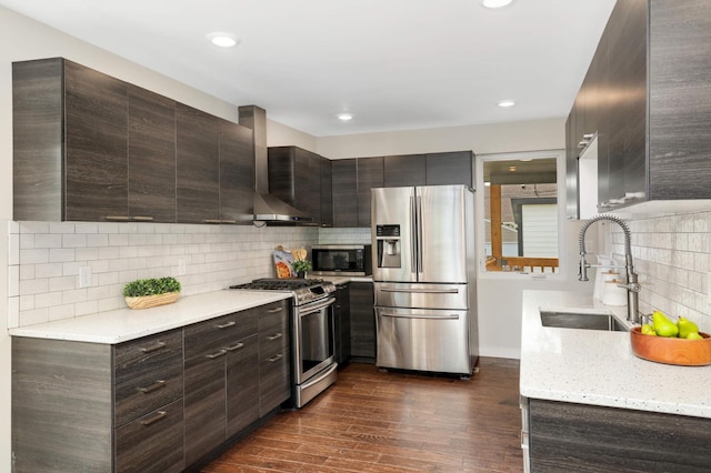 4640 Portland Ave, Minneapolis, MN 55407 - kitchen with appliances with stainless steel finishes, wall chimney range hood, backsplash, dark brown cabinetry, and dark wood-style floors