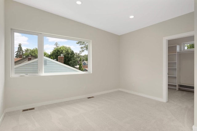 4640 Portland Ave, Minneapolis, MN 55407 - unfurnished bedroom with light carpet, a walk in closet, and recessed lighting