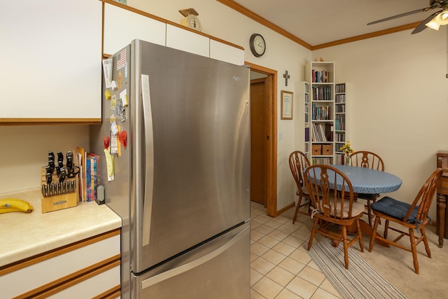1925 Cabernet Ln NW, Rochester, MN 55901 - kitchen featuring freestanding refrigerator, white cabinetry, a ceiling fan, ornamental molding, and light countertops