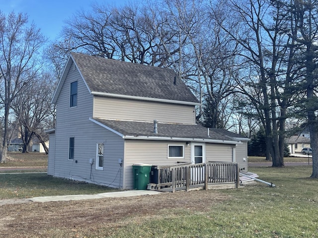 77 Morgan St, Tracy, MN 56175 - rear view of house featuring a wooden deck, a lawn, and roof with shingles