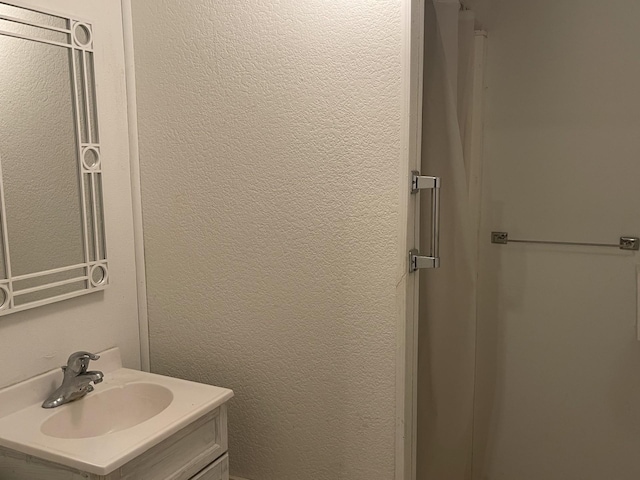 77 Morgan St, Tracy, MN 56175 - bathroom featuring vanity and a textured wall