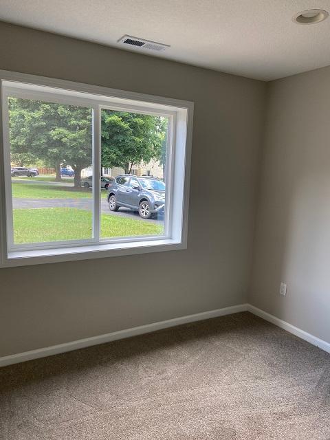 1340 119th Ln NW, Coon Rapids, MN 55448 - spare room with carpet floors and baseboards