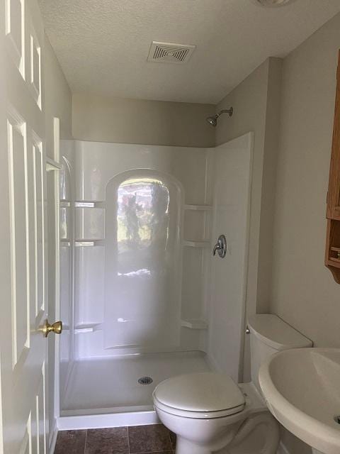 1340 119th Ln NW, Coon Rapids, MN 55448 - bathroom featuring walk in shower and a textured ceiling