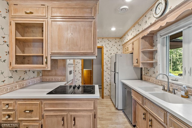 26 Golden Lake Rd, Circle Pines, MN 55014 - kitchen with wallpapered walls, black electric stovetop, stainless steel dishwasher, light countertops, and light brown cabinetry
