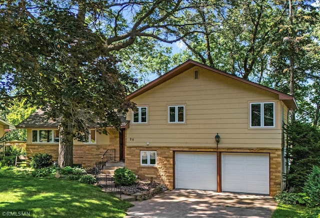 26 Golden Lake Rd, Circle Pines, MN 55014 - view of front of property with a garage, stone siding, driveway, and a front yard