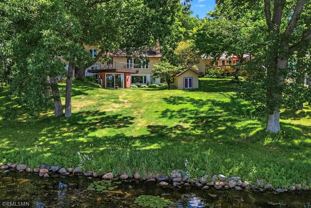 26 Golden Lake Rd, Circle Pines, MN 55014 - view of green lawn with a shed and a wooden deck