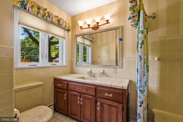 26 Golden Lake Rd, Circle Pines, MN 55014 - full bathroom featuring tile walls, vanity, tile patterned floors, shower / bathtub combination with curtain, and wainscoting