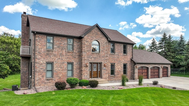 3946 Woodcrest Ct, Eau Claire, WI 54701 - view of front of home with a garage, concrete driveway, a chimney, a front yard, and roof with shingles