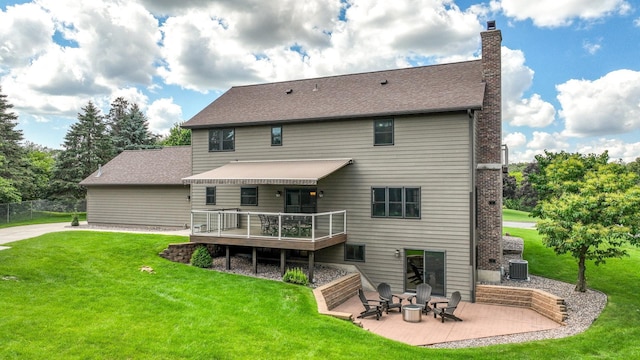 3946 Woodcrest Ct, Eau Claire, WI 54701 - back of property with a chimney, a lawn, a patio, a deck, and roof with shingles