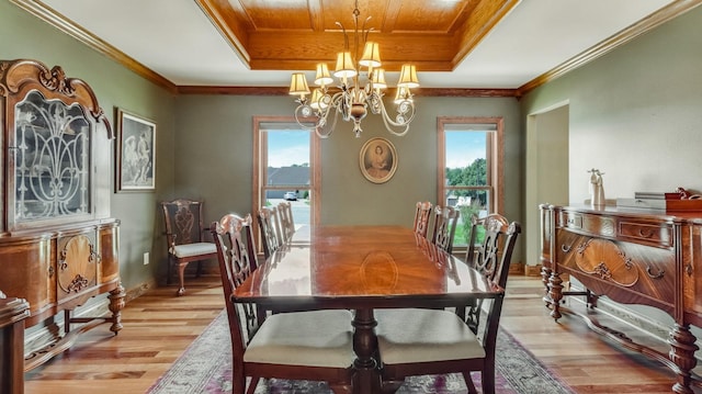3946 Woodcrest Ct, Eau Claire, WI 54701 - dining space featuring plenty of natural light, light wood-type flooring, a chandelier, a tray ceiling, and crown molding