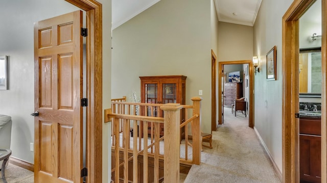 3946 Woodcrest Ct, Eau Claire, WI 54701 - hall with an upstairs landing, crown molding, high vaulted ceiling, and light carpet