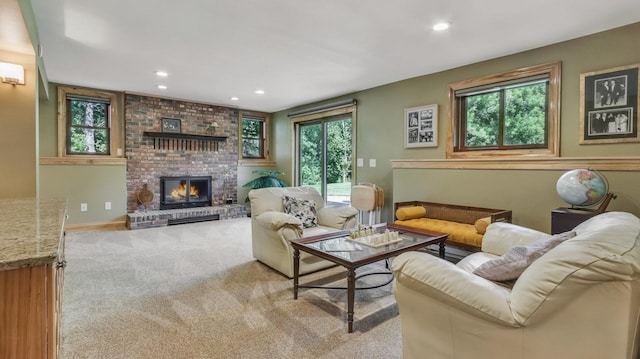 3946 Woodcrest Ct, Eau Claire, WI 54701 - carpeted living area featuring healthy amount of natural light, a brick fireplace, and recessed lighting